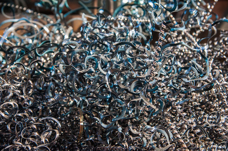 Closeup twisted spiral steel shavings. Scrap metal backgroundの写真素材