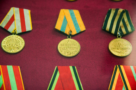Old retro and modern military orders and military medals on red backgroundの写真素材