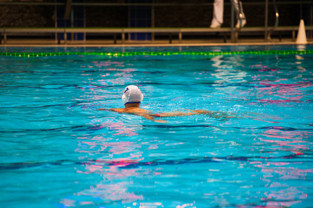 Water polo action in a swimming poolの写真素材