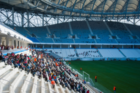 Blurred crowd of spectators on a stadium with a football matchの写真素材
