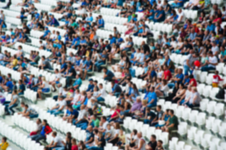 Blurred crowd of spectators on a stadium with a football matchの写真素材