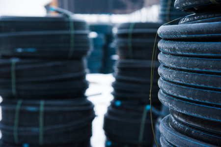 Warehouse of finished plastic pipes industrial outdoors storage site. Manufacture of plastic water pipes factory.の写真素材
