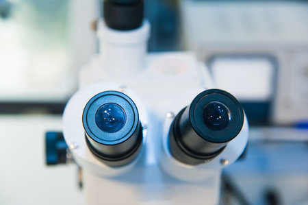 Close-up shot of microscope with metal lens at laboratory