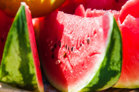 Slices of red ripe watermelon and yellow melon. Fresh fruit