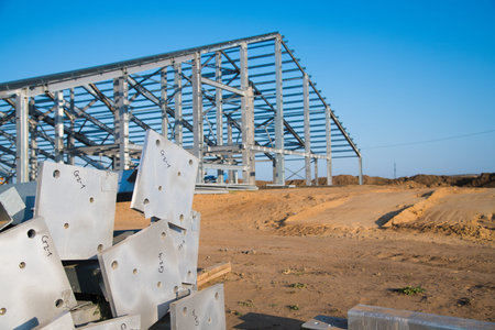 Steel frame workshop is under construction against a blue sky. New technology steel frame for...