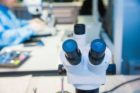 Close-up shot of microscope with metal lens at laboratoryの写真素材