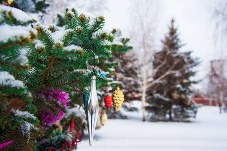 Nice decorations on a Christmas tree with snow outdoorsの写真素材