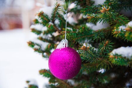 Nice decorations on a Christmas tree with snow outdoorsの写真素材