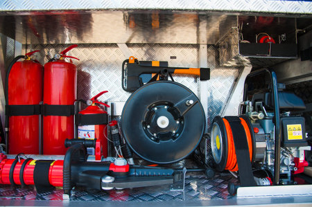 Compartment of rolled up fire hoses on a fire engine. Rescue fire truck equipment