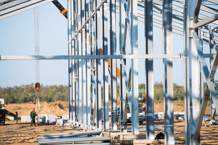 Steel frame workshop is under construction against a blue sky. New technology steel frame for...
