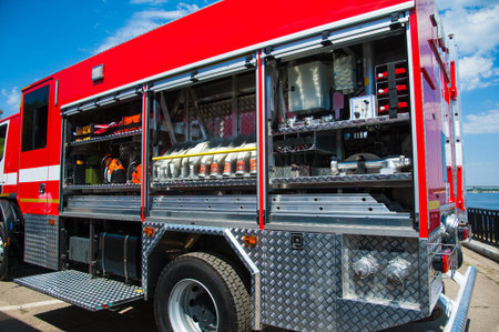 Compartment of rolled up fire hoses on a fire engine. Rescue fire truck equipment