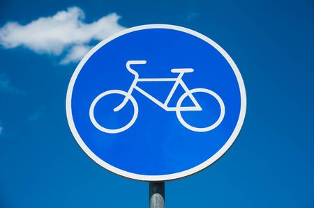 Road sign: Bicycle lane. Road sign against a blue sky.の写真素材