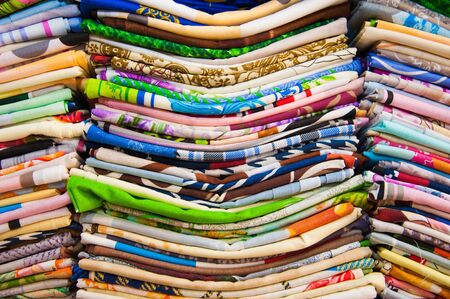 Colorful towels on the shelves in the storeの写真素材