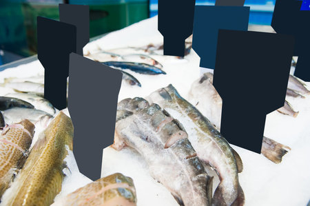 Fish meat product on shelf in the store. Pile of fish on ice