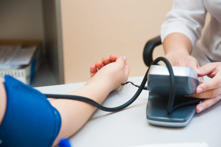 Doctor measuring blood pressure from her patient. Healthcare, hospital and medicine concept