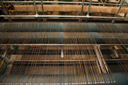 Textile industry - yarn spools on spinning machine in a textile factory