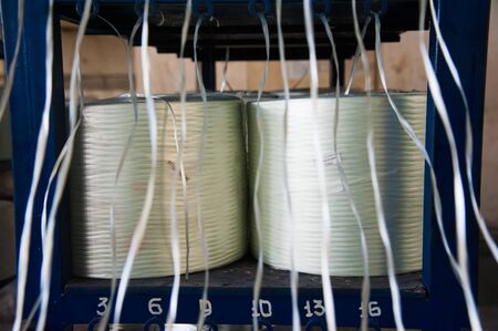 Producing fiberglass rods - manufacture of composite reinforcement, industry for constructionの写真素材
