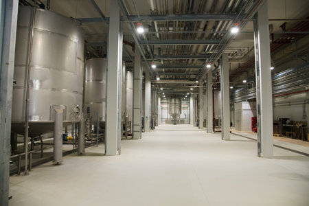 Grain processing facility inside. Industrial factory silos and equipment for food production