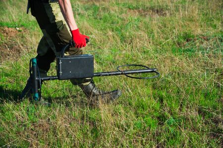 Man with a metal detector in search of a treasureの写真素材
