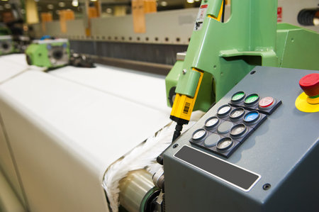 Industrial fabric production line. Weaving looms at a textile factory