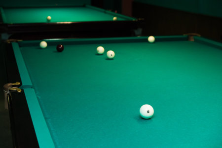 Sports game of billiards on a green cloth. Billiards white billiard balls close up
