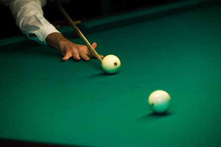Sports game of billiards on a green cloth. Billiards white billiard balls close up