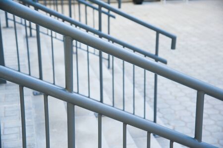 Concrete entrance stairs with metal railings outdoors.の写真素材