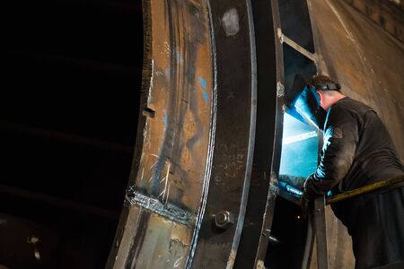 Sparks while welder uses torch to weldingの写真素材
