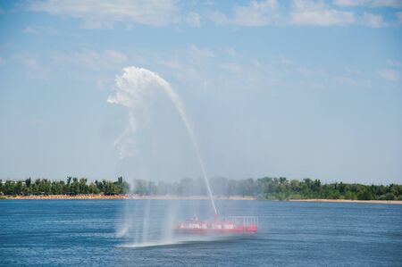 Fire Fighting Boat sprays jets of waterの写真素材