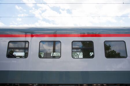 Red train in modern railway central stationの写真素材