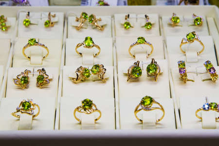 Golden accessories in the display window of a jewelery storeの写真素材