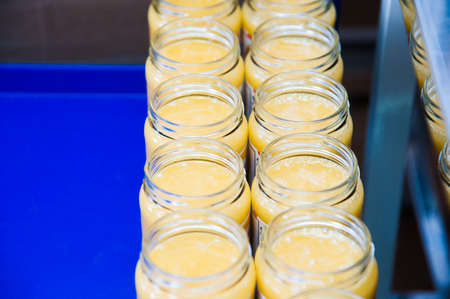 Jars full of organic honey. Production in factoryの写真素材