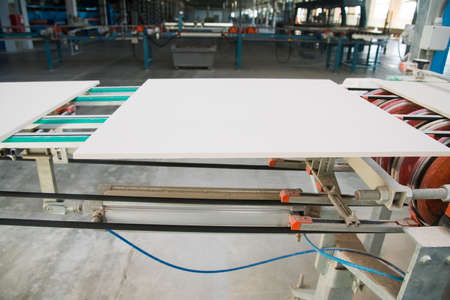 Factory for production of ceramic tiles. Conveyor line for ceramic tile at heavy plant. The process of making ceramic tilesの写真素材