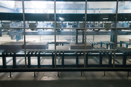 Factory for production of ceramic tiles. Conveyor line for ceramic tile at heavy plant. The process of making ceramic tilesの写真素材