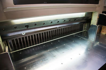 Printing presses at work in the printing. Printed sheets of paper are served in the printing pressの写真素材
