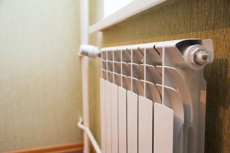 New white radiator on the wall. Heating in the houseの写真素材