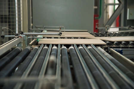 Factory for production of ceramic tiles. Conveyor line for ceramic tile at heavy plant. The process of making ceramic tilesの写真素材