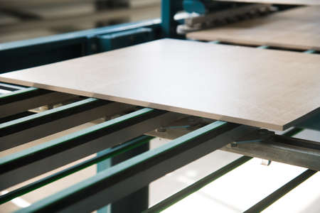Factory for production of ceramic tiles. Conveyor line for ceramic tile at heavy plant. The process of making ceramic tilesの写真素材