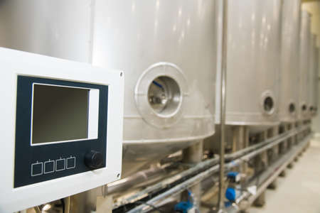 Grain processing facility inside. Industrial factory silos and equipment for food productionの写真素材