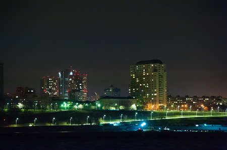 Panorama of the city at night. River in the foreground.の写真素材