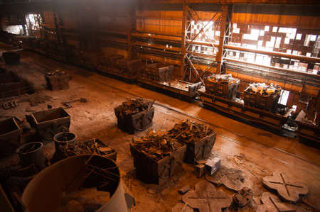 Metal structures and buildings of the old metallurgical plant inside and outside. The process of melting metal. Steelworker at work. Products of the metallurgical enterprise.の写真素材
