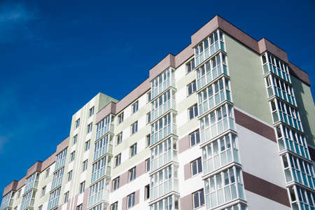 Brand new apartment building against the blue summer skyの写真素材