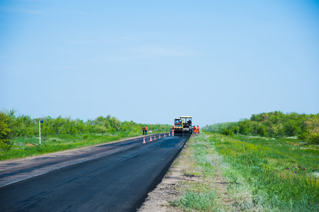 Repair of the old and construction of a new asphalt road. The excavators, graders and road rollers...