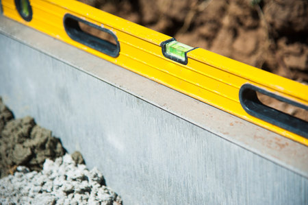 The process of construction of the sidewalk, the installation of a vertical curb