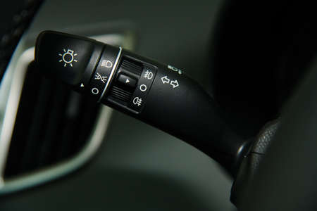 Car interior details close-up. The light knob in the car. Multifunction headlight console control switch knobの写真素材