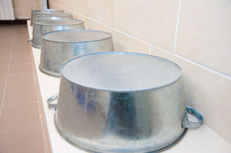Showers in a public shower with tiles and lighting. Common showers in the fitness room or poolの写真素材