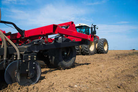Tractor during plowing. Agricultural tillage in springの写真素材