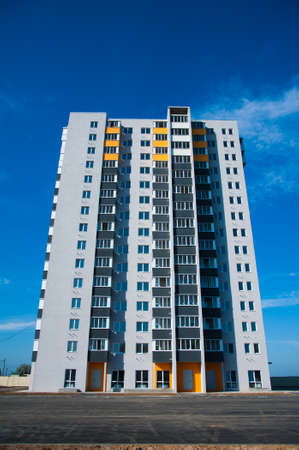 Brand new apartment building against the blue summer skyの写真素材