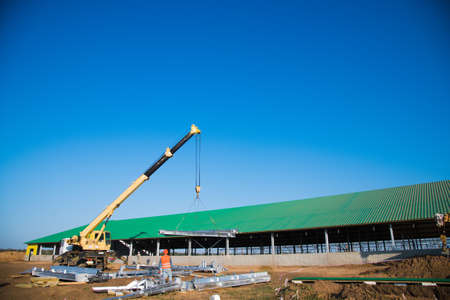Steel frame workshop is under construction against a blue sky. New technology steel frame for constructionの写真素材