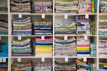 Colorful towels on the shelves in the storeの写真素材